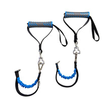 Two resistance bands with blue and black handles on a white round table.