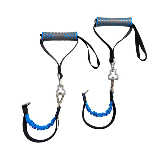 Two resistance bands with blue and black handles on a white round table.