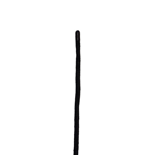 Close-up of a black leash on a white surface with a blurred background